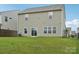 Back of house with sliding glass door leading to a well maintained, lush green lawn at 120 Mooring Dr, Statesville, NC 28677