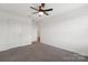 Bright bedroom features a ceiling fan, neutral walls, and carpet flooring at 120 Mooring Dr, Statesville, NC 28677