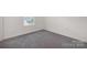 This bedroom features neutral walls, carpet flooring, and a window at 120 Mooring Dr, Statesville, NC 28677