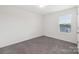 Neutral bedroom features carpet flooring, window, and natural light at 120 Mooring Dr, Statesville, NC 28677