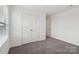 This bedroom features neutral walls, carpet flooring, and double door closet at 120 Mooring Dr, Statesville, NC 28677