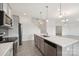 Open-concept kitchen with stainless appliances, island seating, and access to living room at 120 Mooring Dr, Statesville, NC 28677