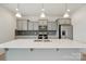 Modern kitchen with white quartz countertops, gray cabinets, and stainless steel appliances at 120 Mooring Dr, Statesville, NC 28677