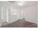 Upstairs loft area with neutral carpet, white walls, and an open view to the first floor at 120 Mooring Dr, Statesville, NC 28677