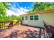 View of back porch, light yellow home, and surrounding trees at 1224 Martin Rd, Hickory Grove, SC 29717