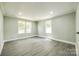 Bright bedroom features gray wood-look floors, recessed lighting, and large windows at 1224 Martin Rd, Hickory Grove, SC 29717