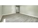 Spacious bedroom with gray wood-look flooring, fresh paint, and two white doors at 1224 Martin Rd, Hickory Grove, SC 29717