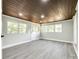 Bright room with wood ceiling, many windows and modern gray flooring, and white trim and doors at 1224 Martin Rd, Hickory Grove, SC 29717