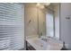 Bathroom vanity featuring a sink, mirror, and blinds providing natural light at 1225 Assembly St, Belmont, NC 28012