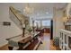 Bright dining area with chandelier lighting, dark wood floors, and open access to the kitchen at 1225 Assembly St, Belmont, NC 28012
