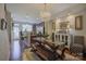 Dining area featuring a chandelier, wood table with benches, and adjacent kitchen view at 1225 Assembly St, Belmont, NC 28012