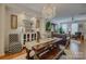 Open-concept dining area with chandelier, a wood table, and connected living space at 1225 Assembly St, Belmont, NC 28012