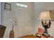 Entryway features a white door with glass transom, warm wood floors and decorative accent pieces at 1225 Assembly St, Belmont, NC 28012
