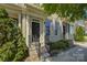 Charming brick townhouse with a black front door, trimmed bushes and well-manicured front yard at 1225 Assembly St, Belmont, NC 28012