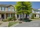Street view of brick townhouses, showcasing manicured landscaping and traditional architectural style at 1225 Assembly St, Belmont, NC 28012
