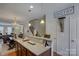 Kitchen with breakfast bar and granite countertops overlooks dining and living areas at 1225 Assembly St, Belmont, NC 28012