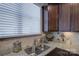 The kitchen boasts a stainless steel sink with granite countertops and elegant dark wood cabinets at 1225 Assembly St, Belmont, NC 28012