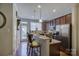 Galley kitchen featuring stainless steel appliances, granite countertops, and breakfast bar seating at 1225 Assembly St, Belmont, NC 28012