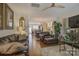 Open-concept living room featuring hardwood floors, chandelier, and modern furnishings at 1225 Assembly St, Belmont, NC 28012