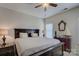 This primary bedroom showcases a large bed with a ceiling fan and nice décor at 1225 Assembly St, Belmont, NC 28012