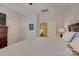 Light filled bedroom boasts a ceiling fan, neutral walls, and easy access to the en-suite bathroom at 1225 Assembly St, Belmont, NC 28012