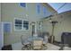 Inviting patio with dining set, overhead lighting, grill, and well-maintained exterior at 1225 Assembly St, Belmont, NC 28012