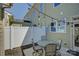 Cozy backyard patio with a seating area, string lights, and privacy fence at 1225 Assembly St, Belmont, NC 28012