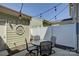 Charming patio area with outdoor dining set, string lights, and green exterior at 1225 Assembly St, Belmont, NC 28012