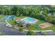 Aerial view of community pool, clubhouse, playground, and tennis courts at 1310 Bellhook Nw Pl, Concord, NC 28027