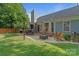 Spacious backyard with patio, fire pit, lawn, and covered grilling area, ideal for gatherings at 1310 Bellhook Nw Pl, Concord, NC 28027