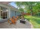 Cozy backyard with fire pit, stone patio and adirondack chairs, perfect for relaxing in the outdoors at 1310 Bellhook Nw Pl, Concord, NC 28027