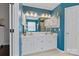 Bright blue bathroom vanity featuring a double sink and updated lighting fixtures at 1310 Bellhook Nw Pl, Concord, NC 28027