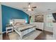 Comfortable bedroom with a large bed, dark wood floors, and a serene blue accent wall at 1310 Bellhook Nw Pl, Concord, NC 28027