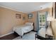Comfortable bedroom with a cozy bed, artwork, and a view to the backyard at 1310 Bellhook Nw Pl, Concord, NC 28027
