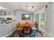 Cozy dining room with a wooden table, six chairs, and a view of the backyard at 1310 Bellhook Nw Pl, Concord, NC 28027