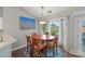 Bright dining room with wood table, large window, and modern light fixture at 1310 Bellhook Nw Pl, Concord, NC 28027
