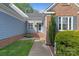 Inviting entrance featuring brick accents, well-maintained landscaping, and a charming walkway at 1310 Bellhook Nw Pl, Concord, NC 28027