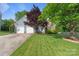 Charming home featuring a well-manicured lawn, mature trees and an attached two-car garage at 1310 Bellhook Nw Pl, Concord, NC 28027