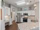Bright kitchen with white cabinets, stainless steel appliances, and granite countertops at 1310 Bellhook Nw Pl, Concord, NC 28027