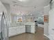 Open-concept kitchen with stainless steel appliances, breakfast bar, and seamless flow to living area at 1310 Bellhook Nw Pl, Concord, NC 28027