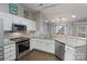 Modern kitchen with stainless steel appliances, granite countertops and tile backsplash at 1310 Bellhook Nw Pl, Concord, NC 28027