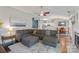 Open living room with a gray sectional, leading into the kitchen and dining area at 1310 Bellhook Nw Pl, Concord, NC 28027