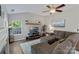 Bright living room featuring vaulted ceilings, a ceiling fan, and a large sectional sofa at 1310 Bellhook Nw Pl, Concord, NC 28027