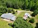 A peaceful home and buildings are perched on acres of land with gorgeous foliage and a long driveway at 140 Dalu Ln, Harmony, NC 28634