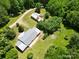 A beautiful home and additional buildings are surrounded by mature trees on expansive acreage at 140 Dalu Ln, Harmony, NC 28634