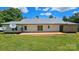 Home's backyard featuring a concrete patio, white siding, metal roof and lush green grass at 140 Dalu Ln, Harmony, NC 28634