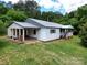 Charming single story home with white siding, metal roof, covered entry, and lush green lawn at 140 Dalu Ln, Harmony, NC 28634