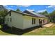 Back of home with white siding, metal roof, patio, and green surroundings at 140 Dalu Ln, Harmony, NC 28634
