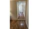 Hallway with hardwood floors connects to various rooms in the home at 140 Dalu Ln, Harmony, NC 28634