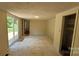 Large room with light colored walls, ceiling light, a door, and sliding glass door at 140 Dalu Ln, Harmony, NC 28634